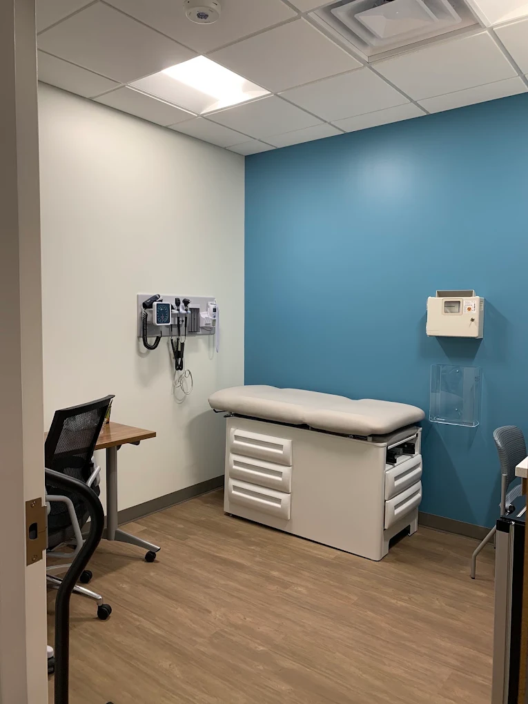 Private exam room with examination table and medical equipment