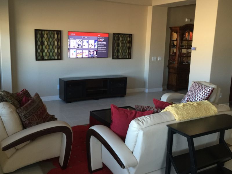 Mounted TV with sofas and modern wall decor