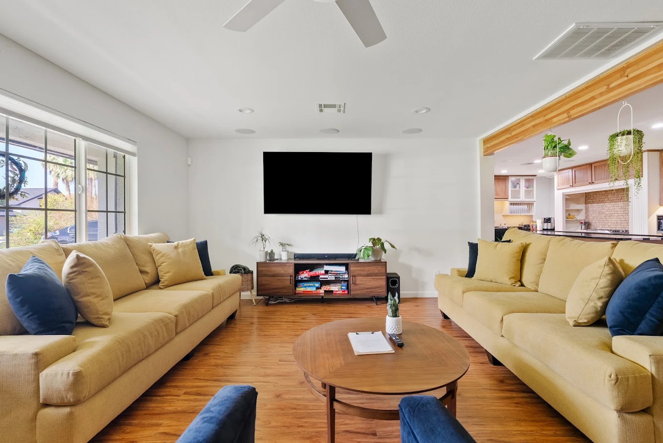 Living room with sofas, coffee table, and wall-mounted TV