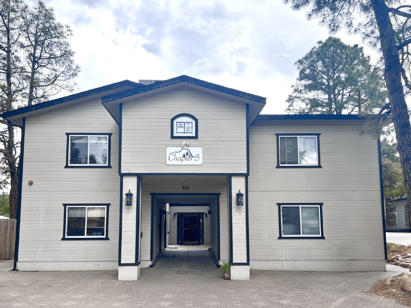 Two-story main building with central breezeway and signage