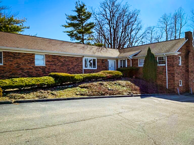 Brick building with front shrubs and driveway in Bloomington
