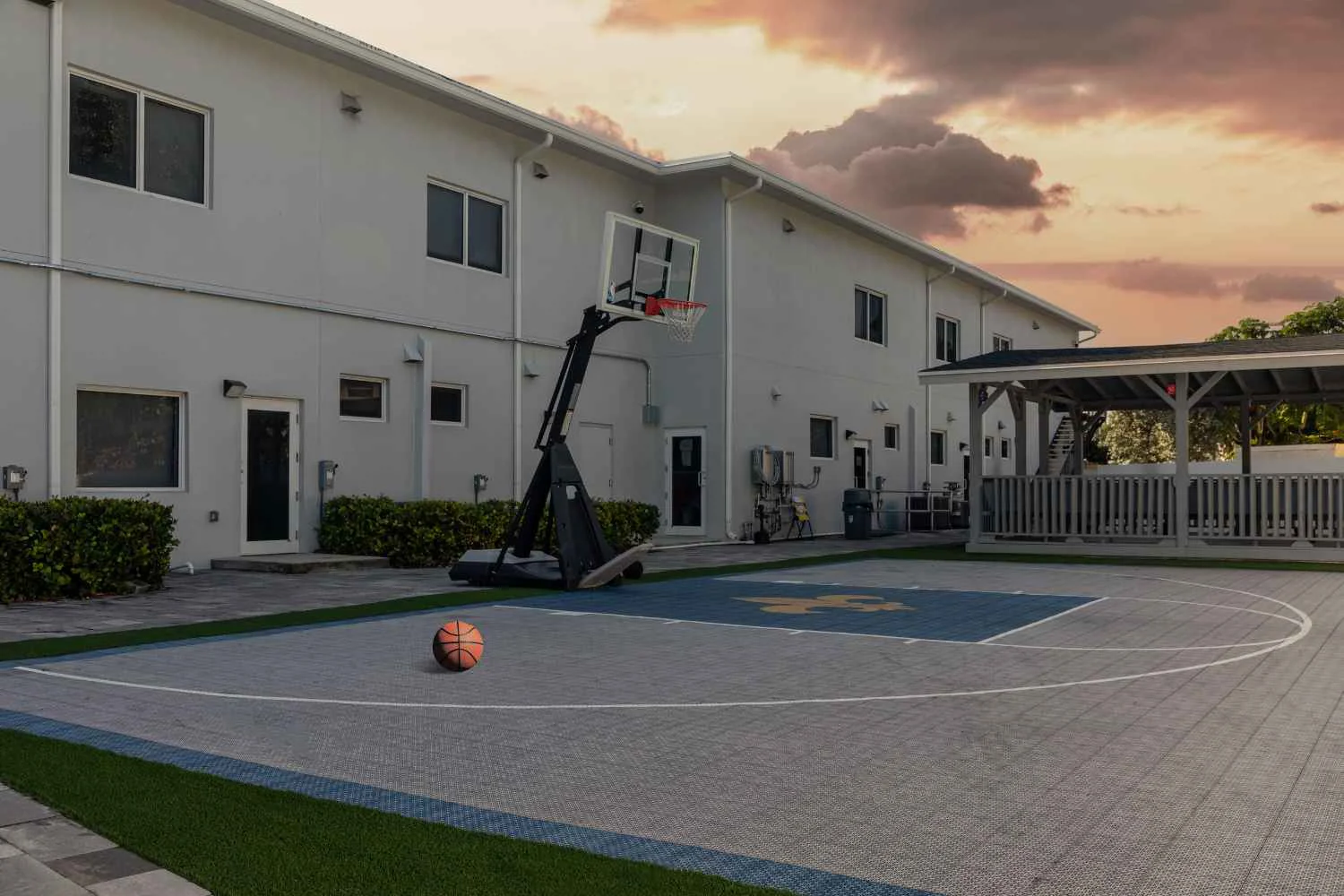 Basketball court with shaded patio area.