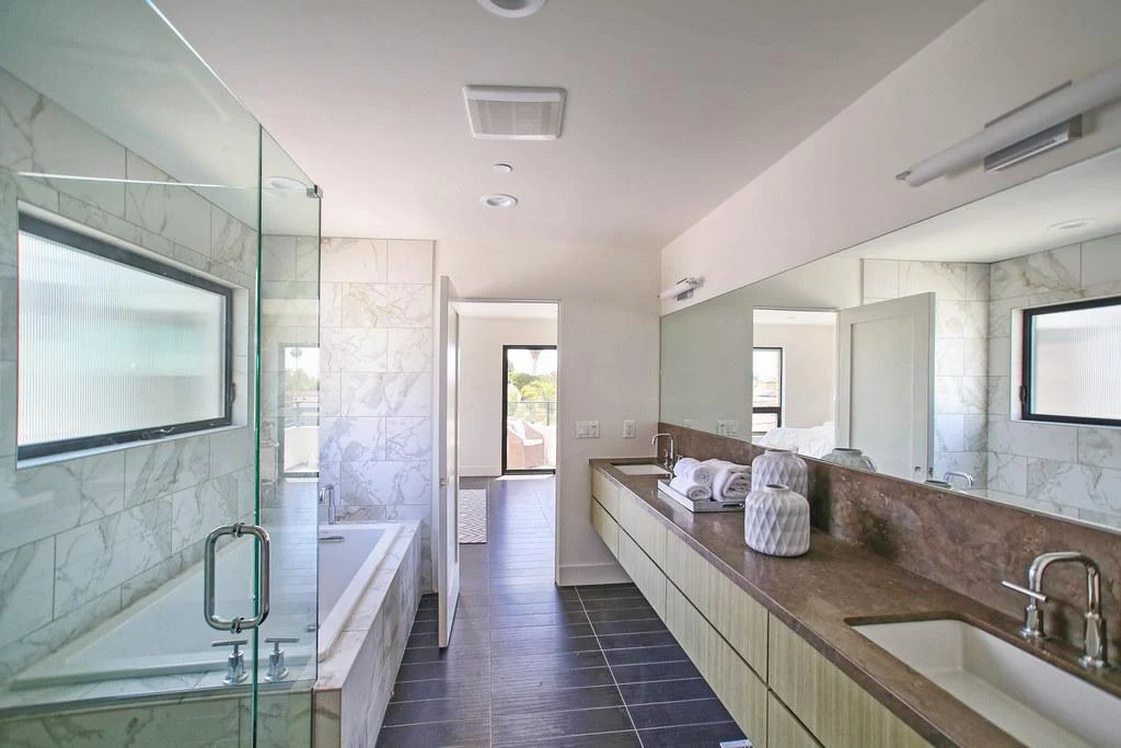 Modern bathroom with long vanity and marble tub