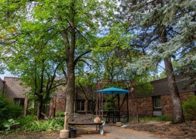 Shaded courtyard with picnic table and umbrella