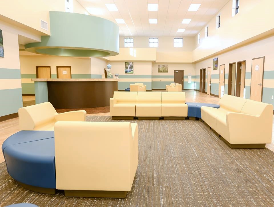 Yellow and blue seating in a bright open lobby