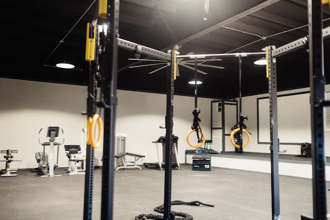 Gym with strength training rigs and cardio machines