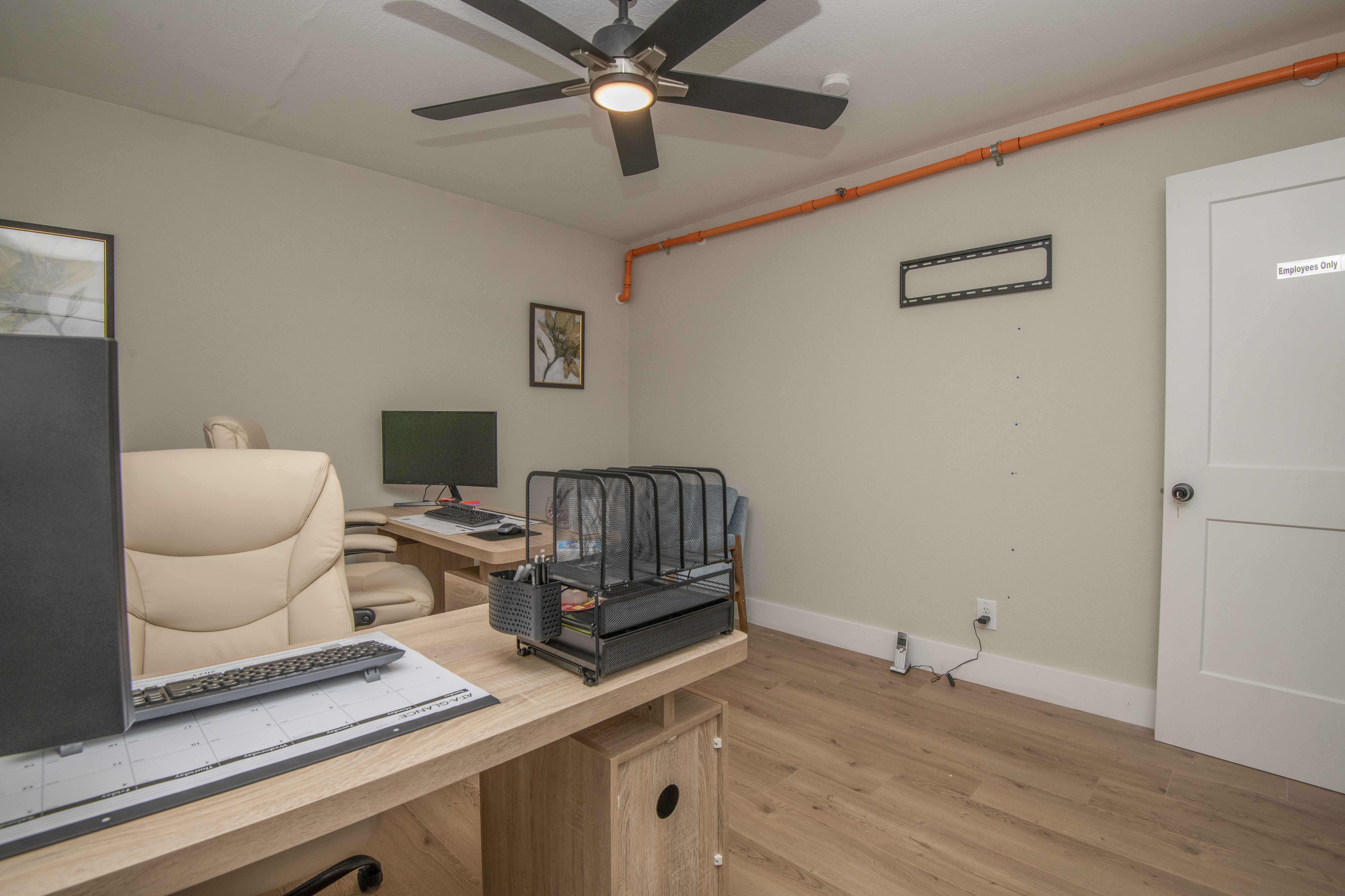 Office with desk, computer, and beige chair