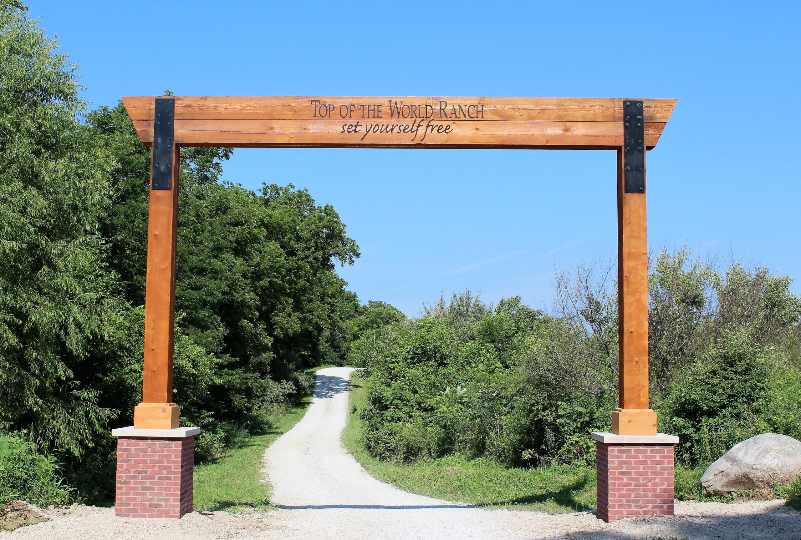 Entrance gate to Top of the World Ranch surrounded by trees