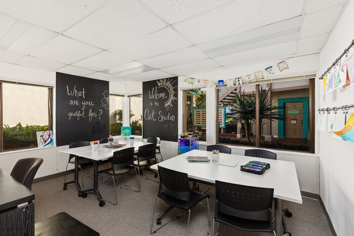 Art therapy studio with tables and creative workstations
