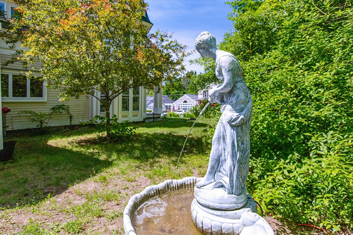 Outdoor statue with water fountain near trees