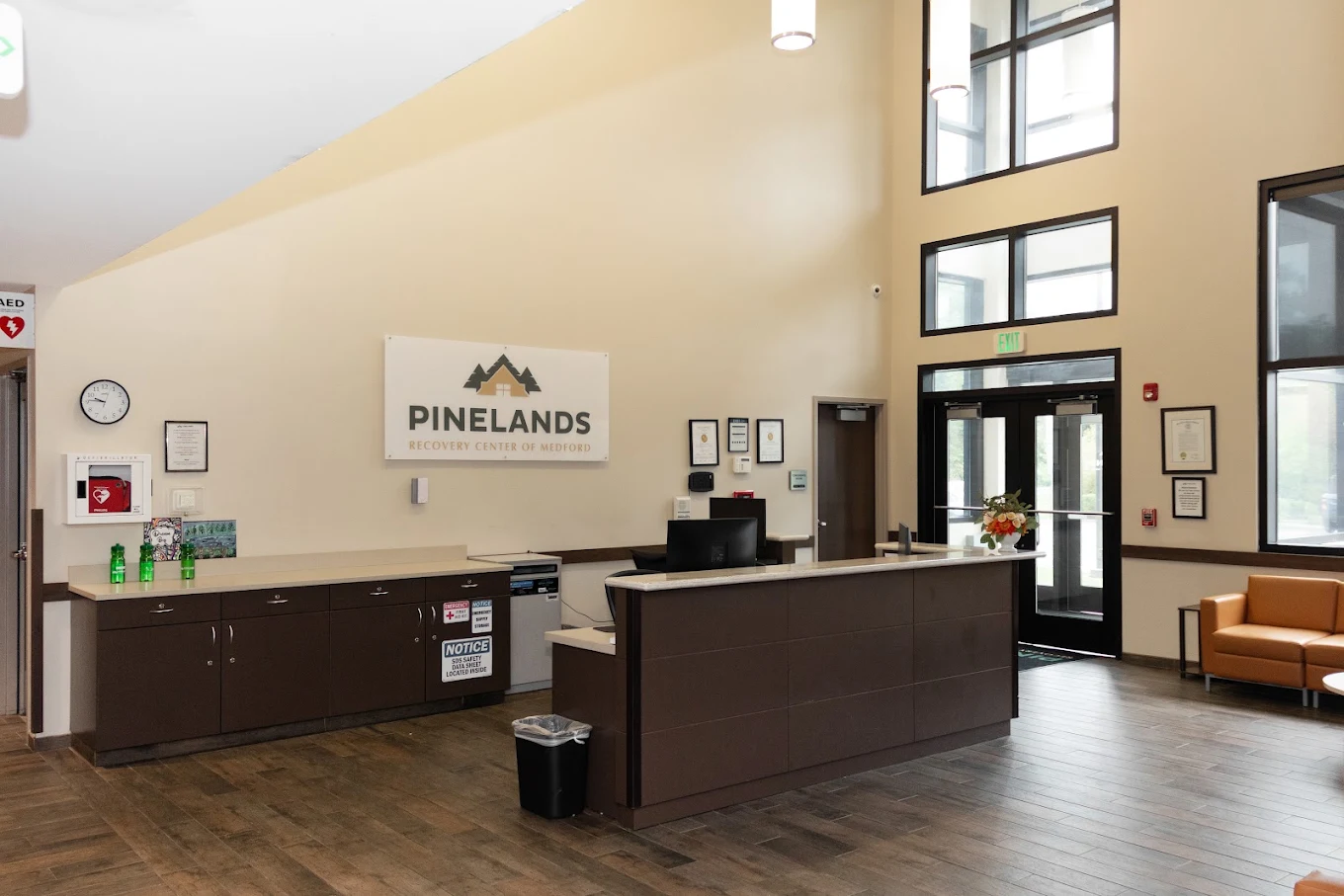 Reception area with front desk, high ceilings, and seating