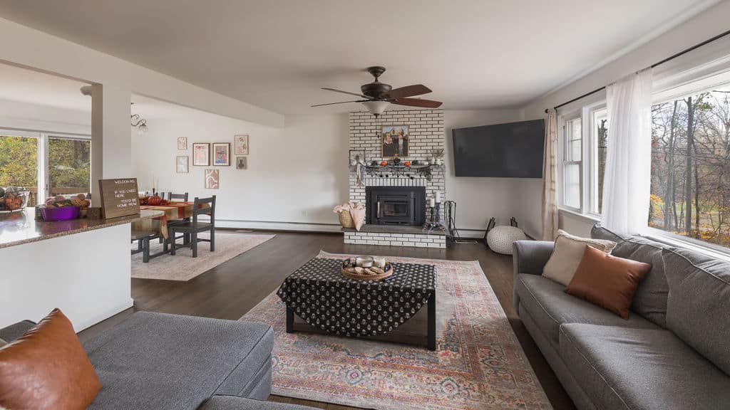 Cozy lounge with gray sofas, fireplace, and large windows