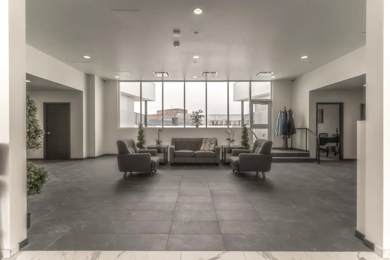 Spacious waiting lounge with sofas and balcony view