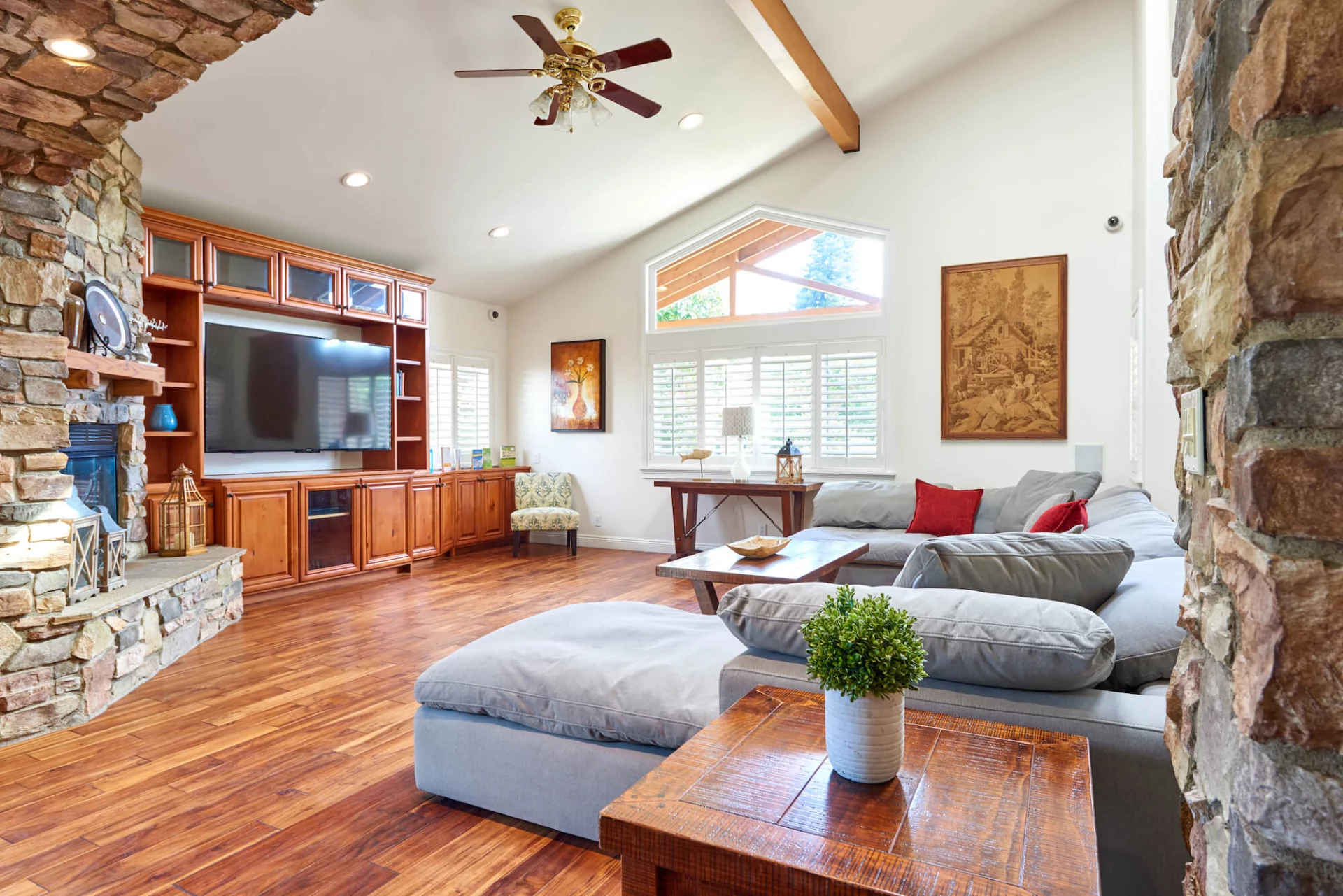 Spacious TV room with sectional sofa and fireplace