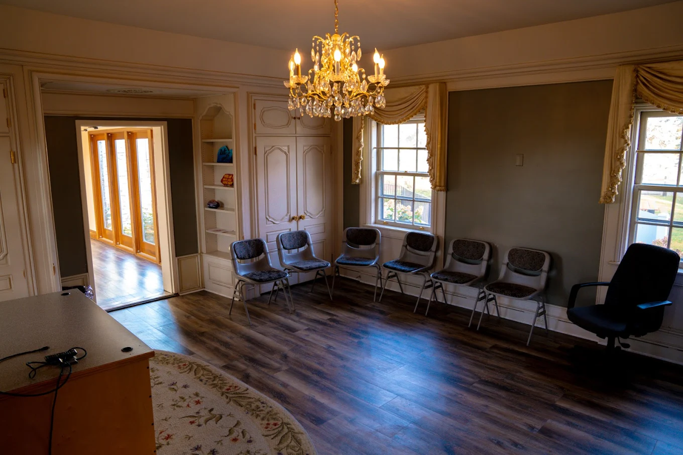 Group therapy room with chairs arranged under chandelier at Beauterre
