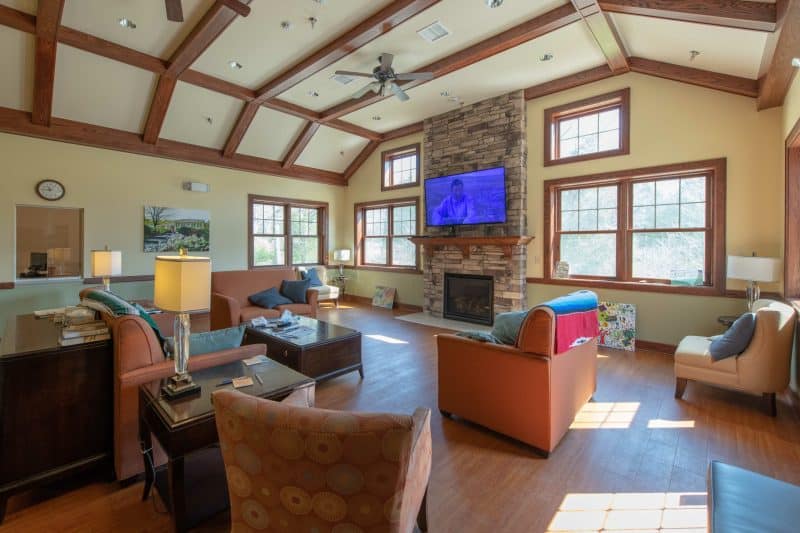 Cozy lounge with couches, fireplace, and TV