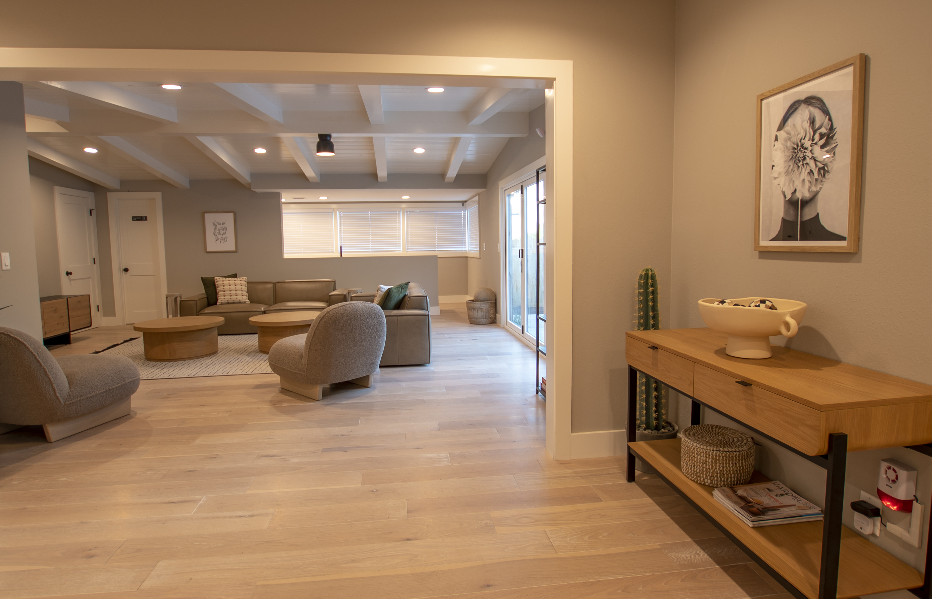 Modern lounge with a sectional sofa, round tables, and soft lighting