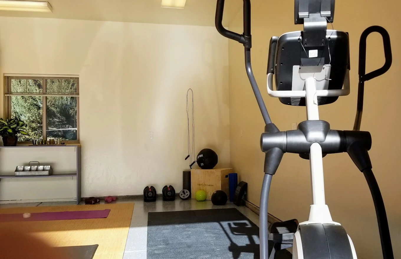 Elliptical and weights in a well-lit workout space