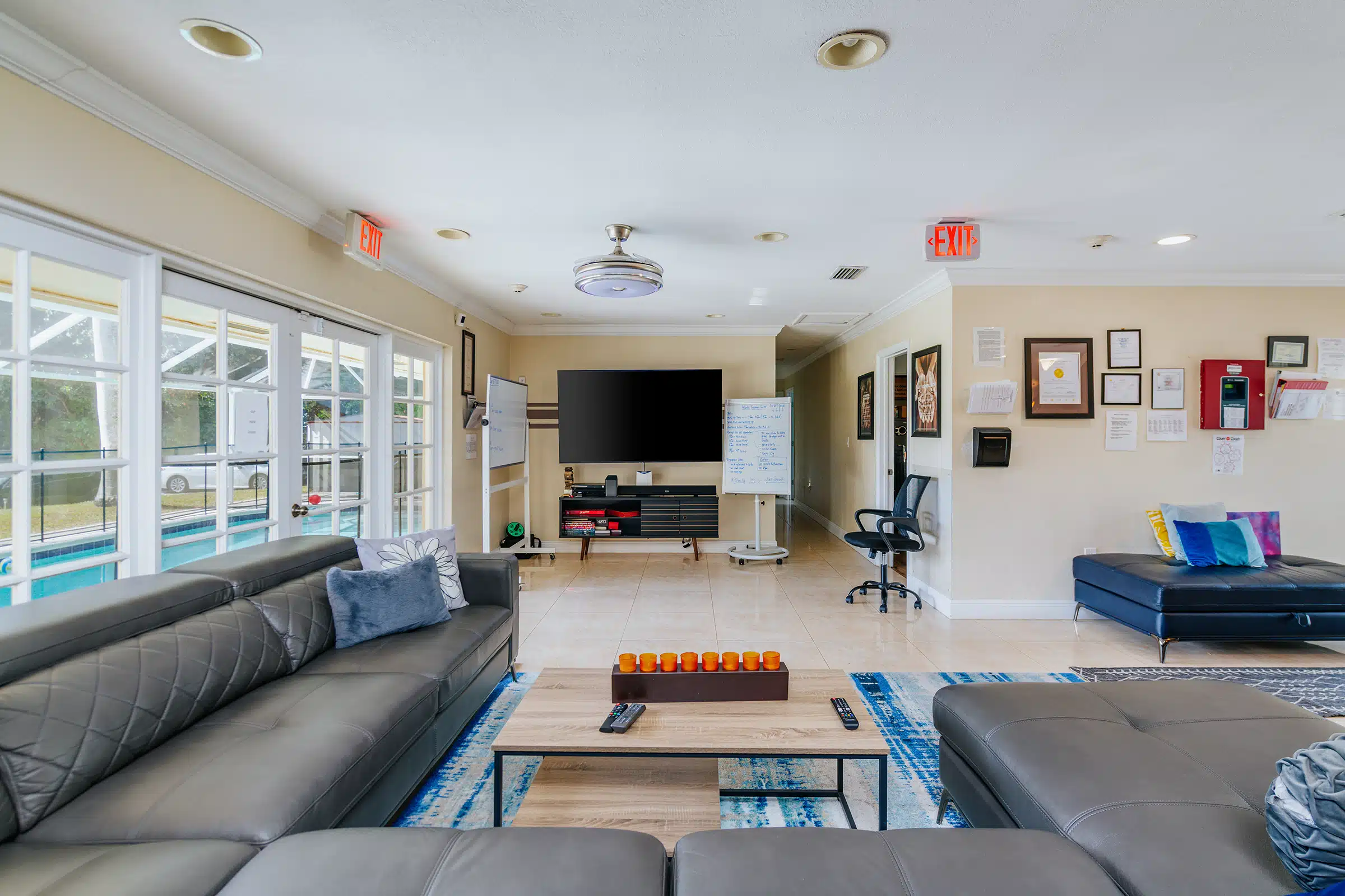 Living room with couches, TV, and whiteboard