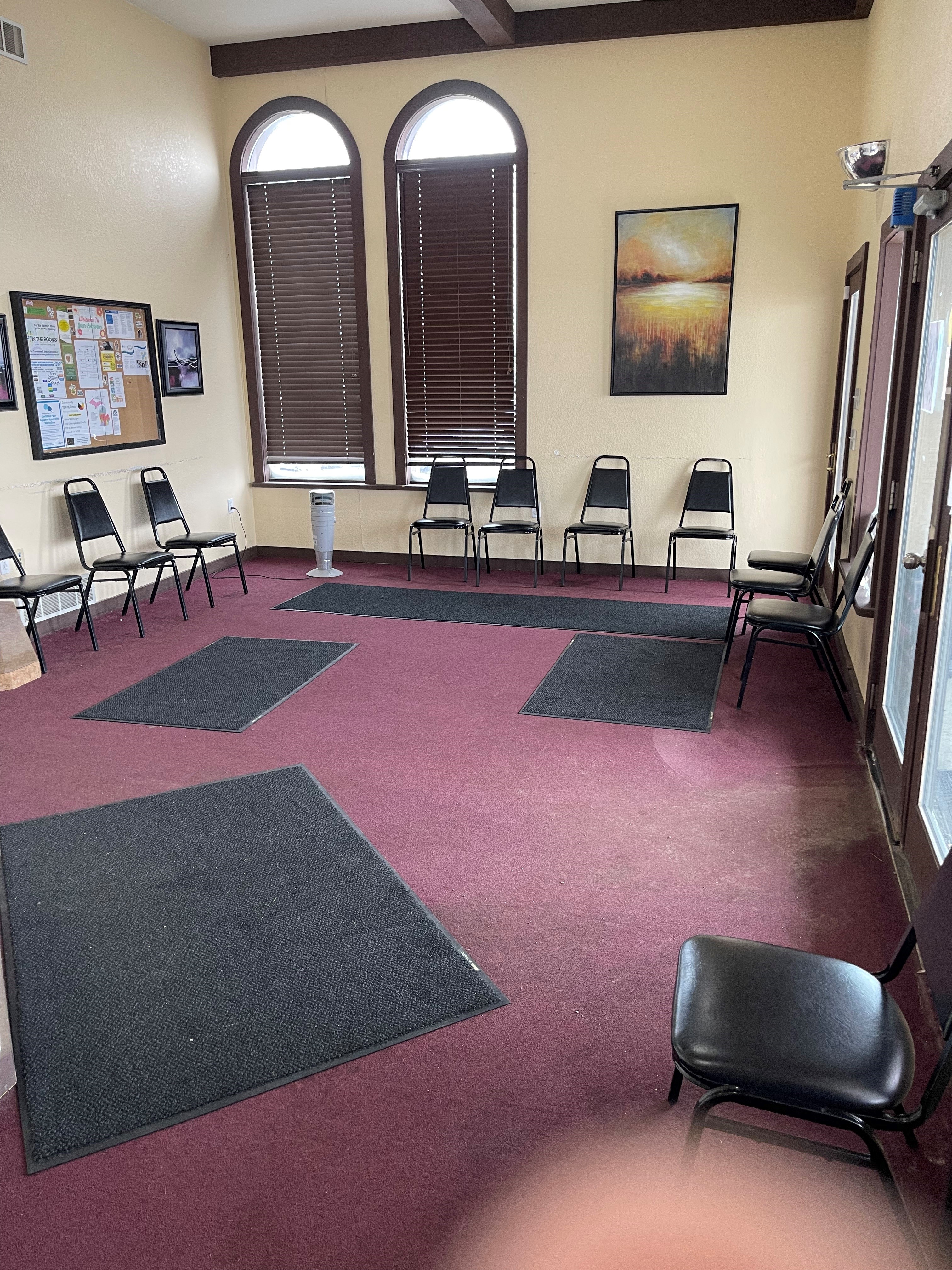 Lobby waiting area with chairs and tall arched windows