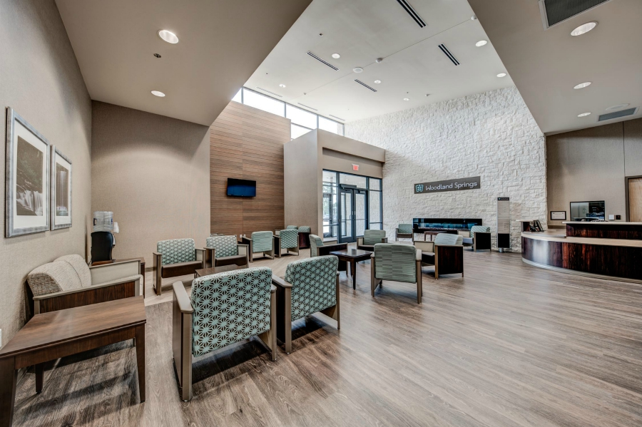 Reception area with chairs and wood flooring