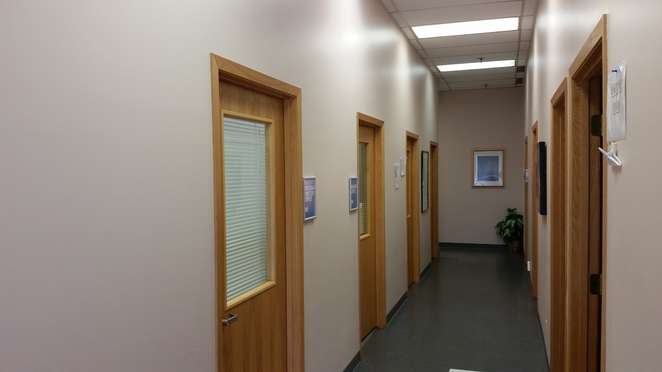 Hallway with wooden doors and offices.
