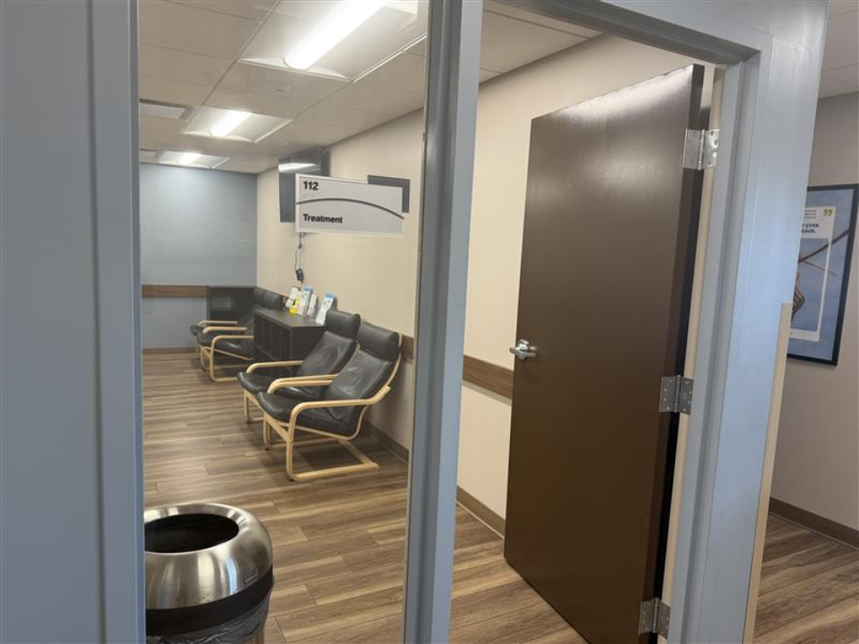 BrightView Health Batavia treatment room with patient seating, wood-look flooring, and treatment room entrance