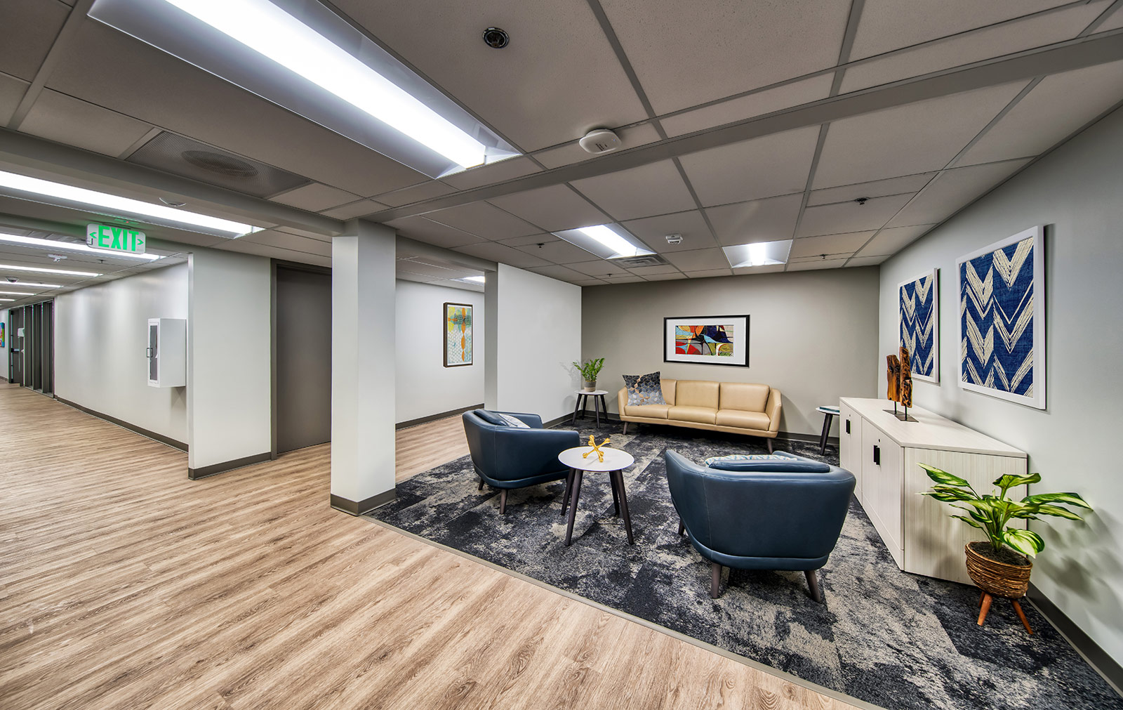 Hallway seating area with chairs, couch, and decor