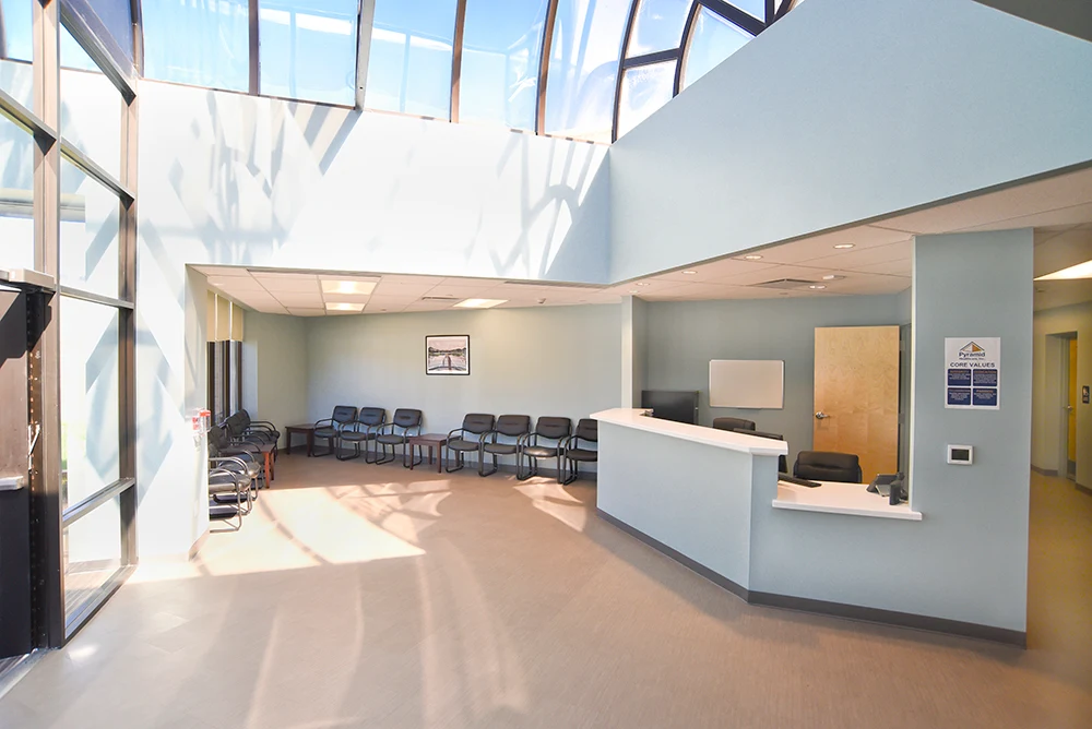 Bright reception area with front desk and waiting chairs