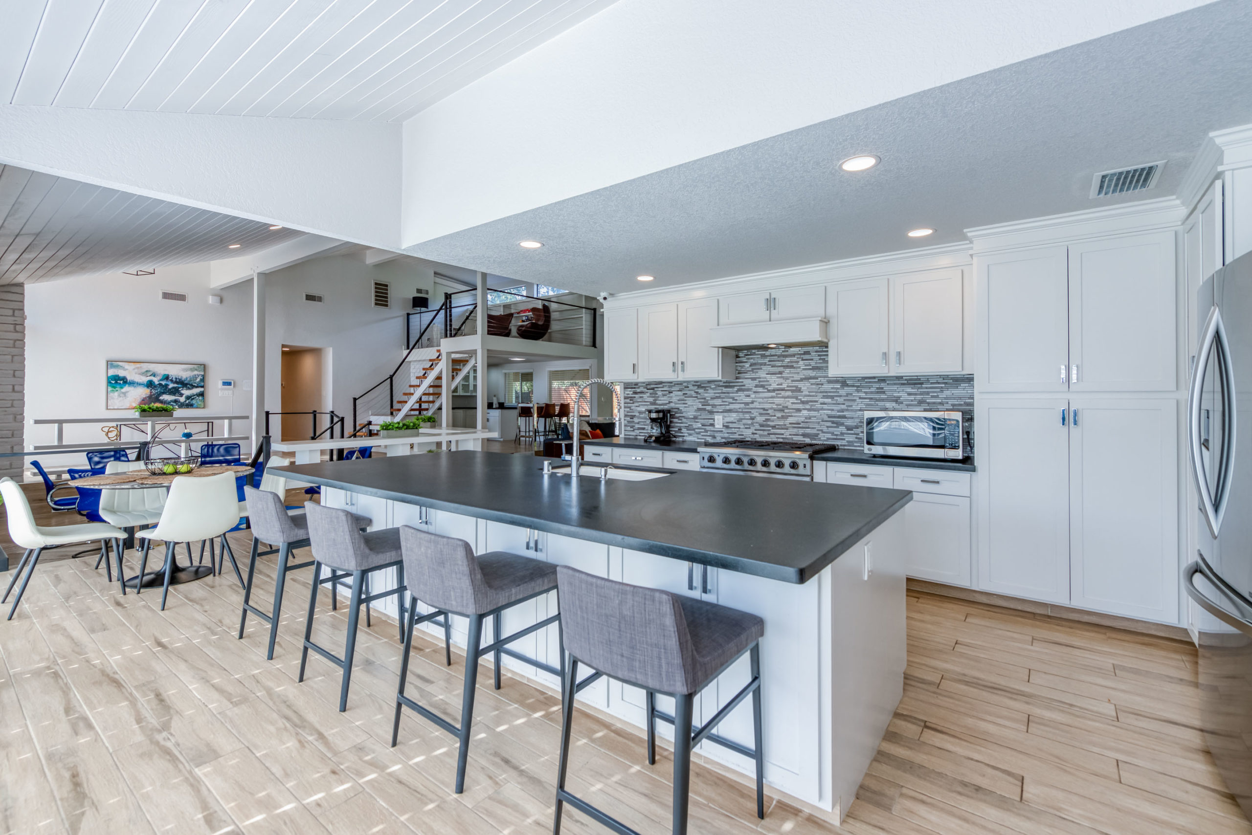 Large open kitchen with island and dining tables