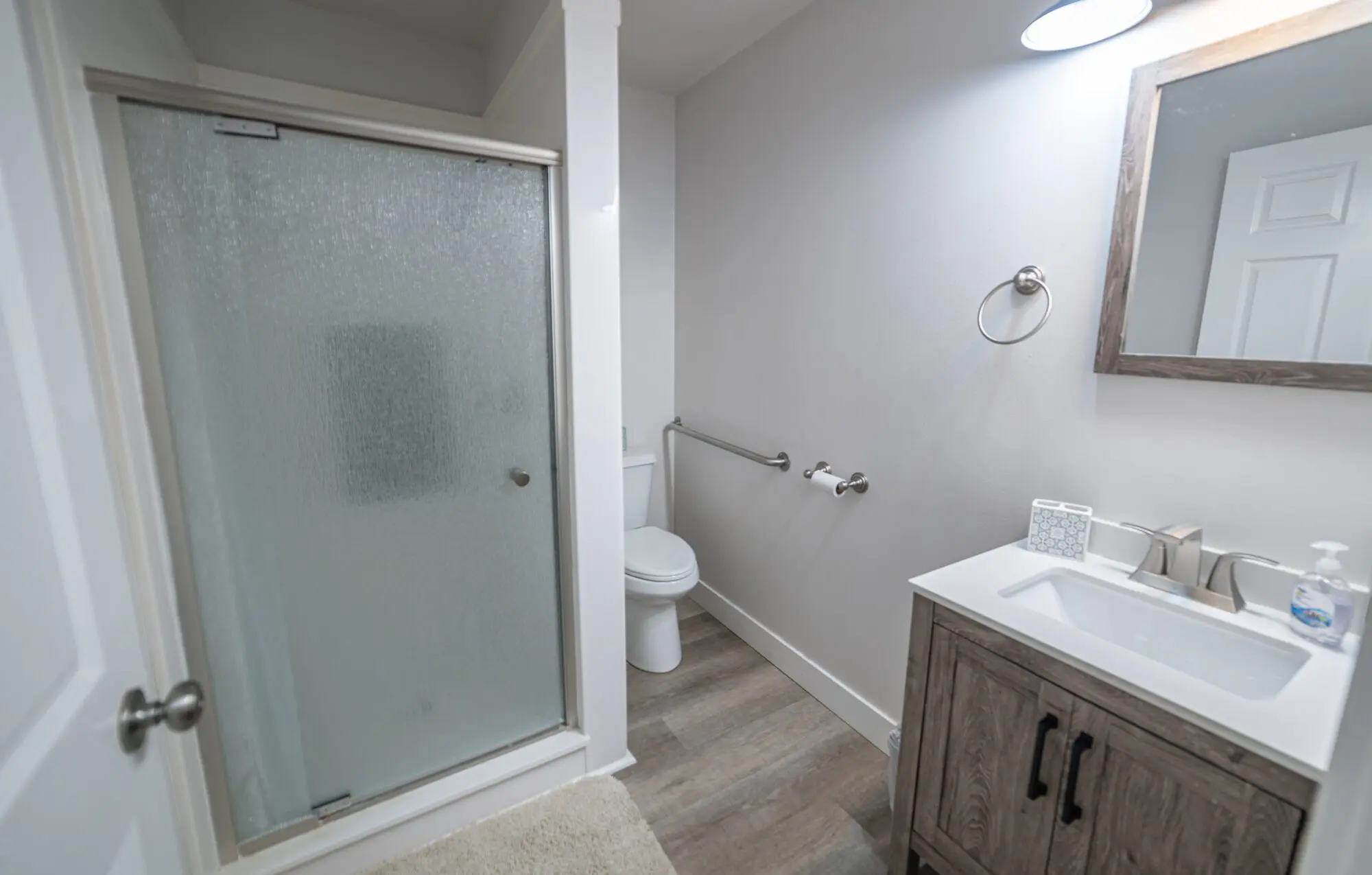 Clean residential bathroom with walk-in shower and vanity