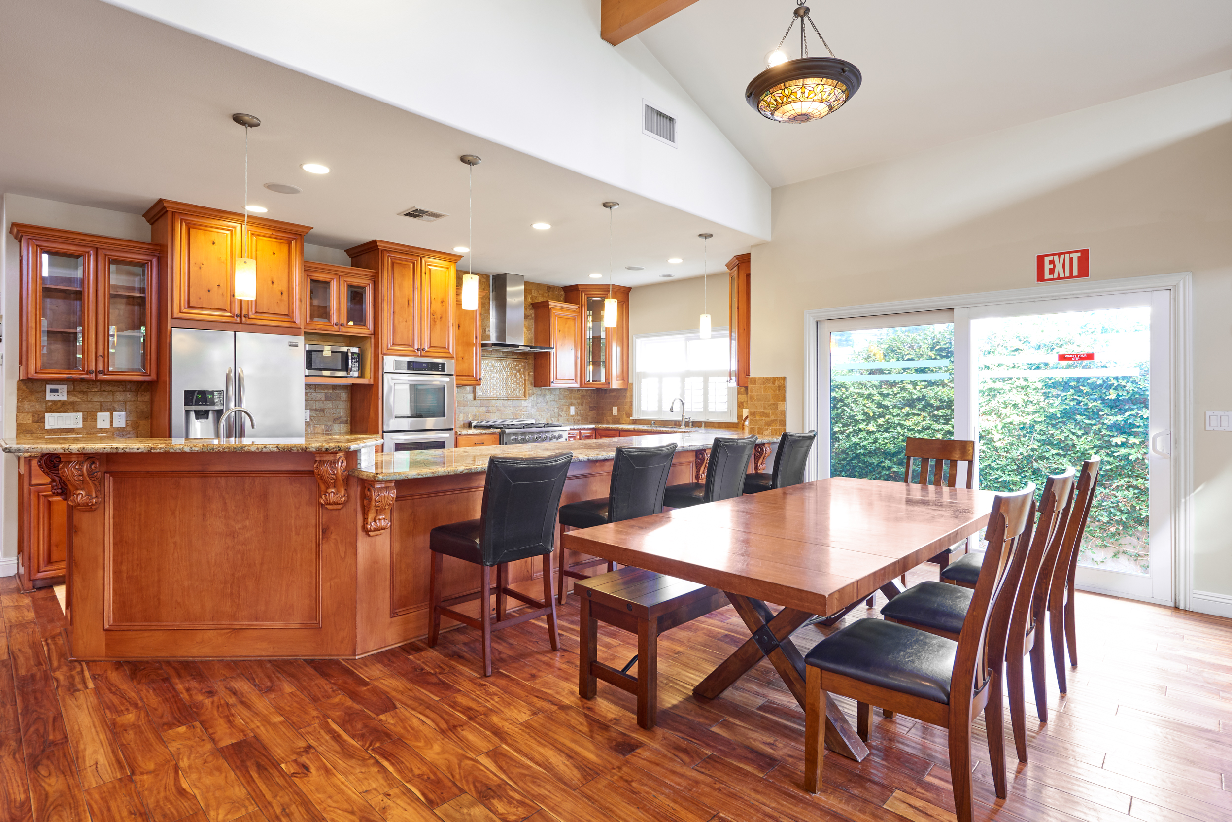 Open kitchen with wood cabinets and large dining table