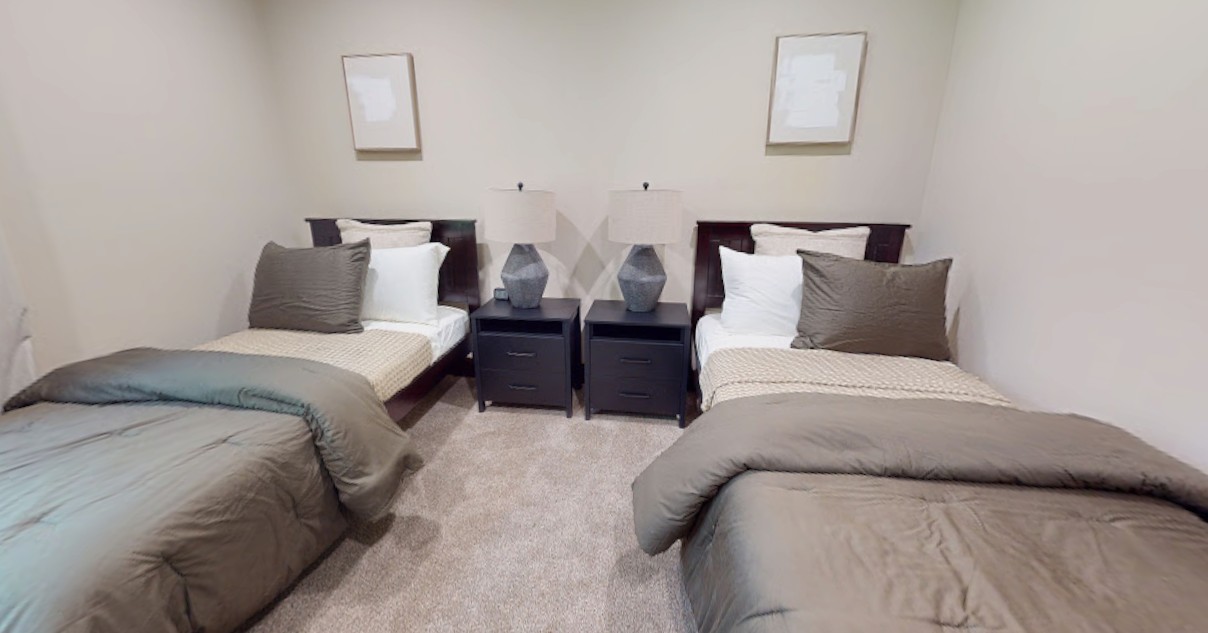 Shared bedroom with two beds and matching nightstands