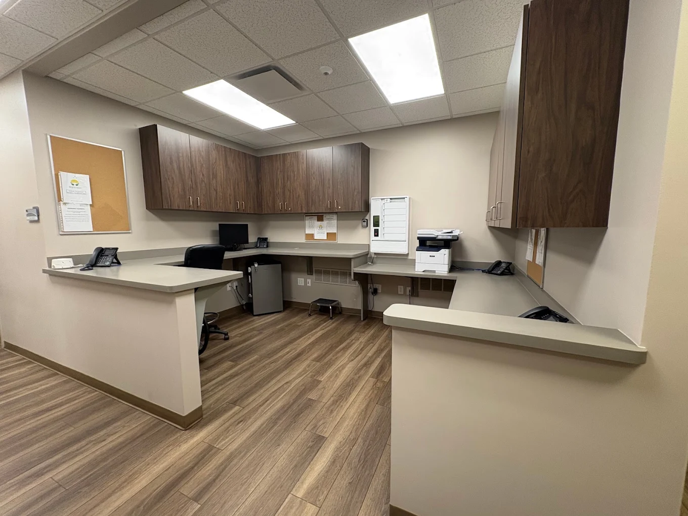 Reception workstation with counters, cabinets, and office equipment