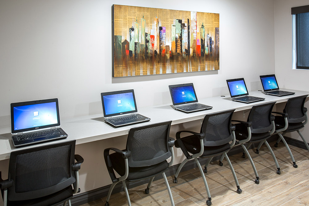 Computer station with multiple laptops in residential facility