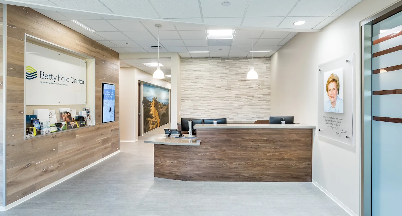 Betty Ford Center reception area with a wood-front desk, informational displays, and a portrait on the wall