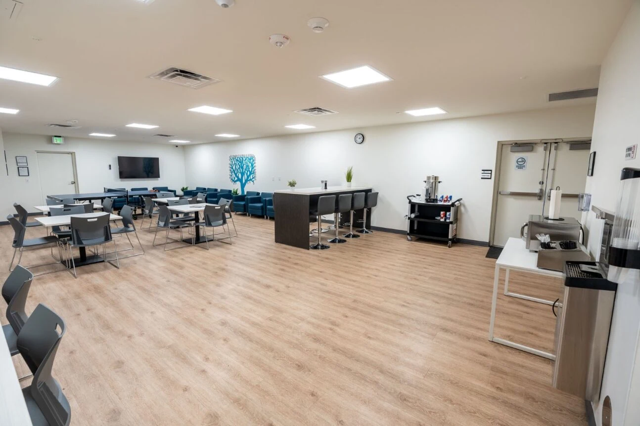 Open seating area with tables and lounge chairs