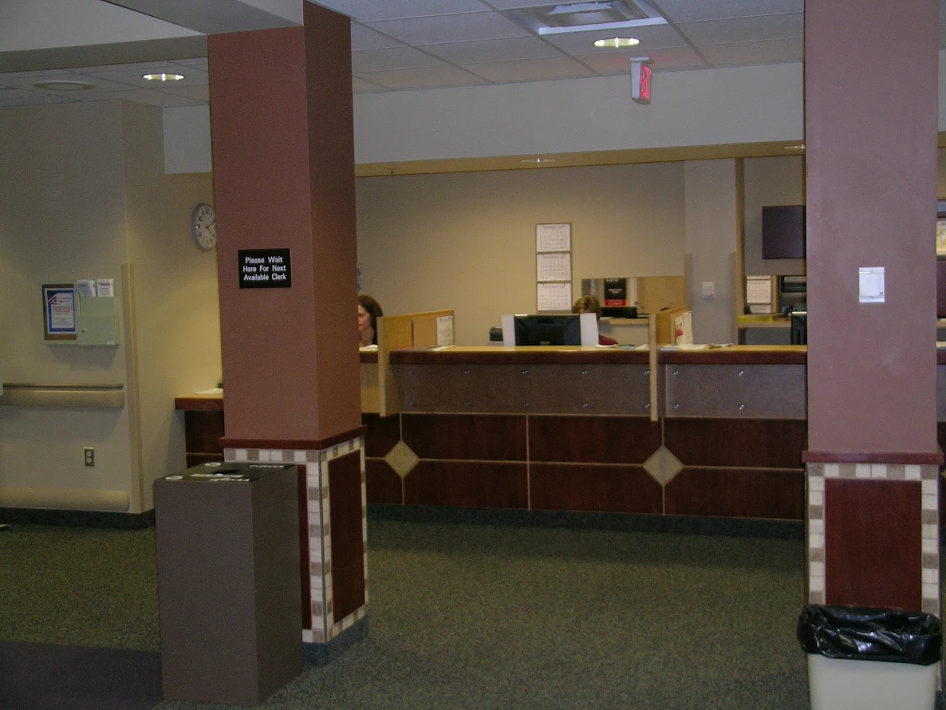 Reception desk with wooden counter and seating area