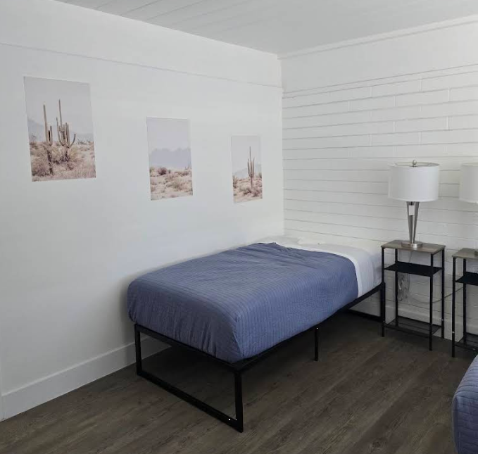 Private bedroom with single bed and bedside tables