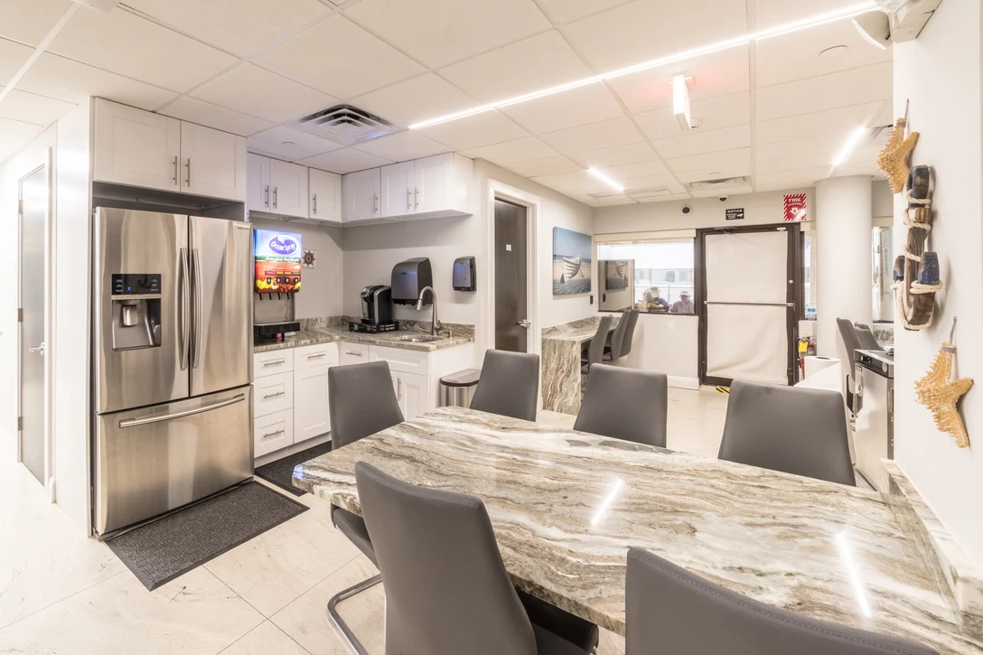 Shared kitchen with stainless appliances and granite table