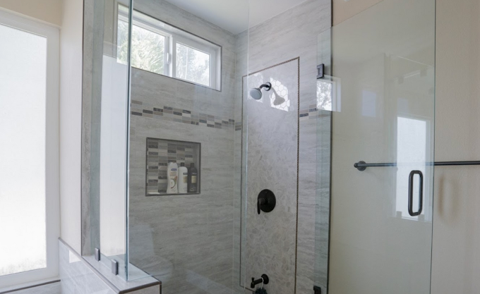 Glass shower with tile walls and built-in product niche