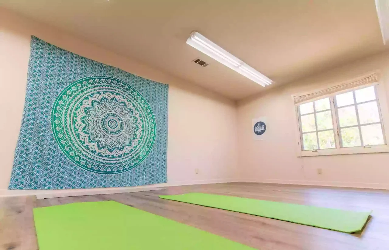 Yoga and meditation room with mats and wall tapestry