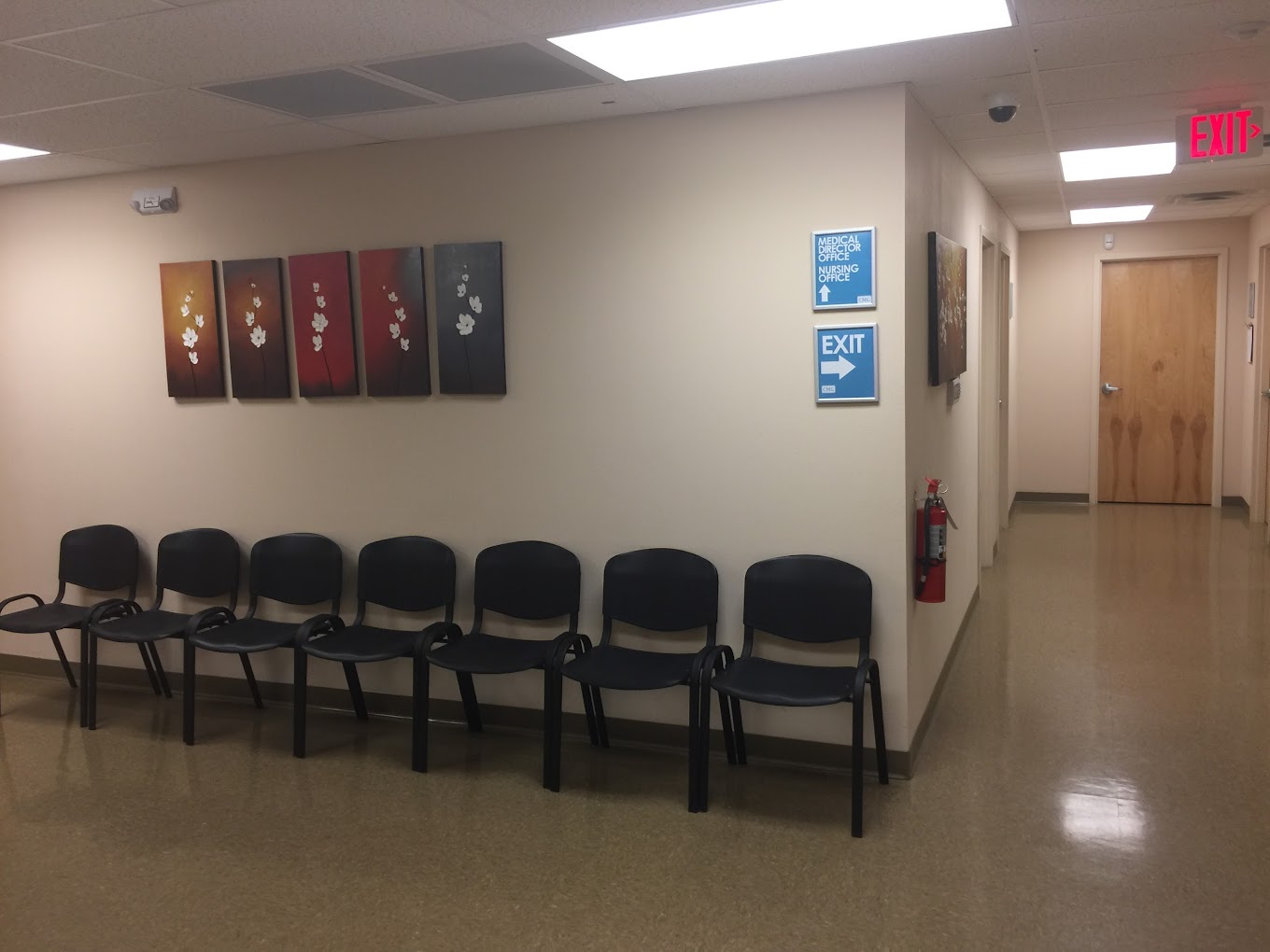 Waiting area with chairs along the wall.