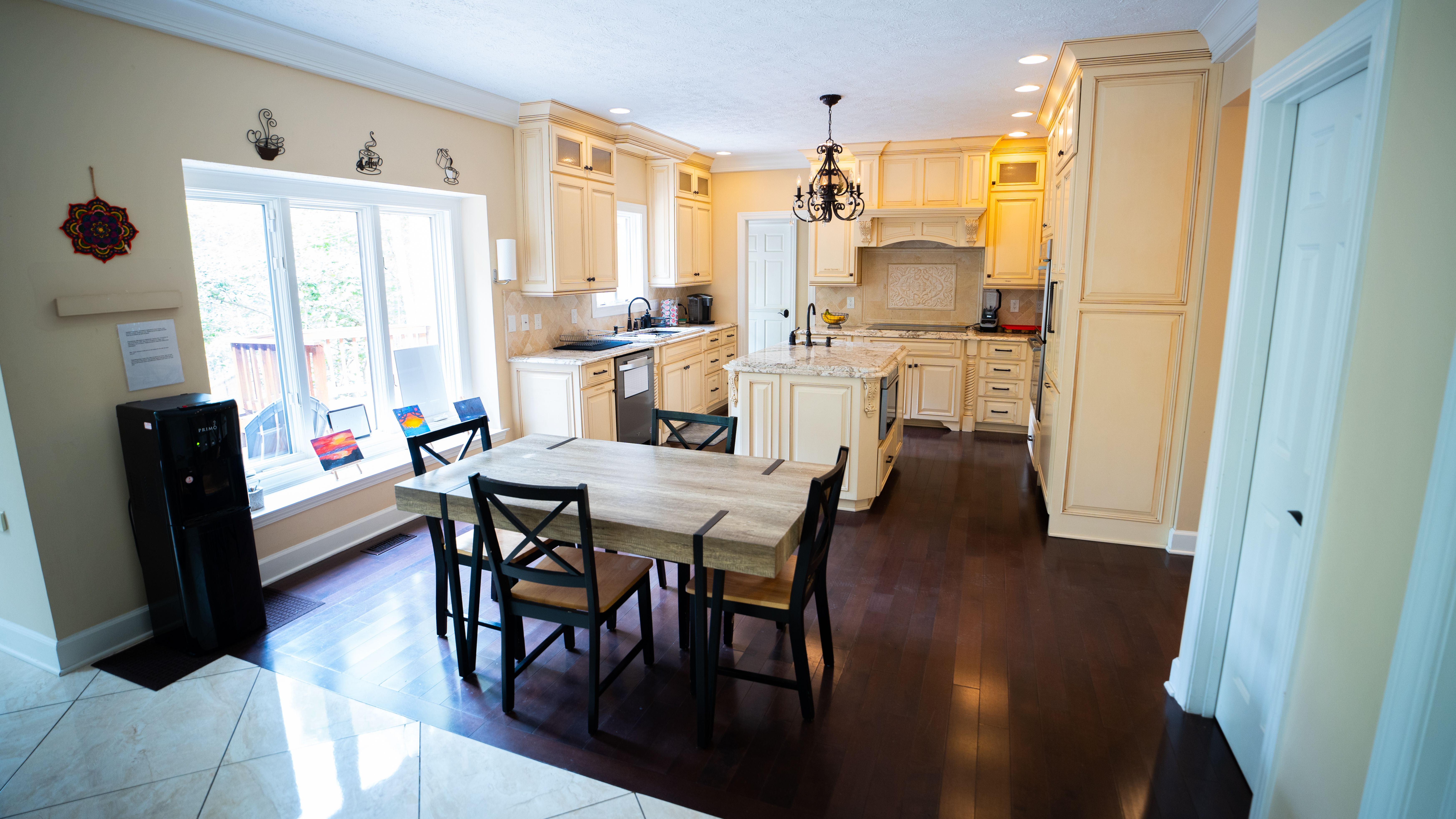 Large kitchen with wood cabinets and small dining table