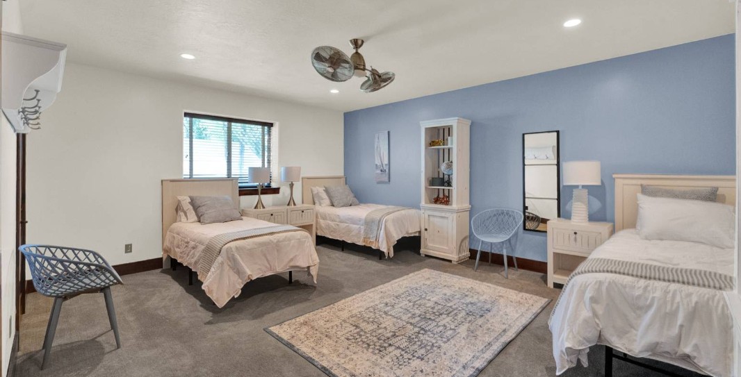 Shared bedroom with three beds and coordinated furnishings