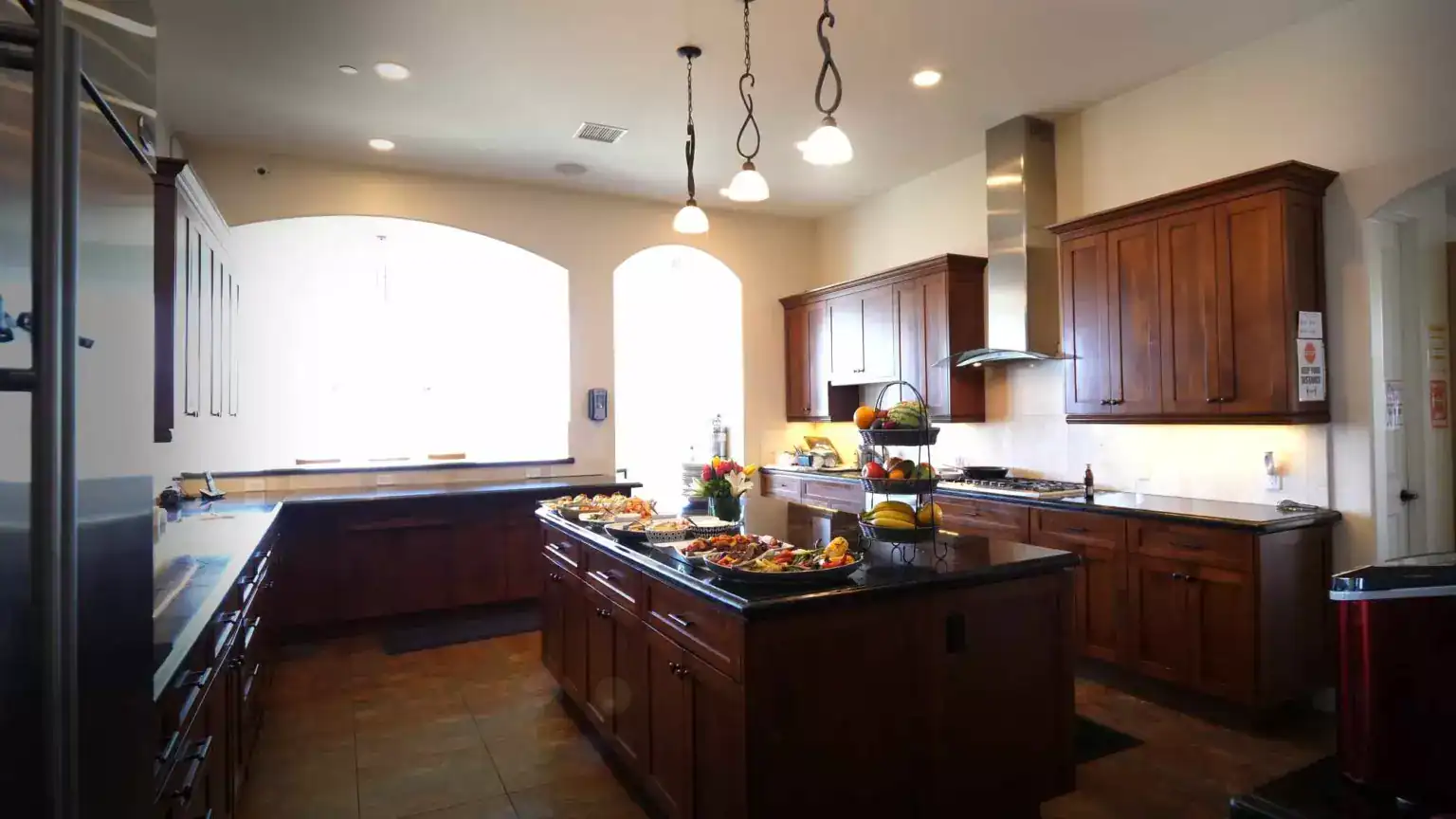 Kitchen with wood cabinets, island, and pendant lighting