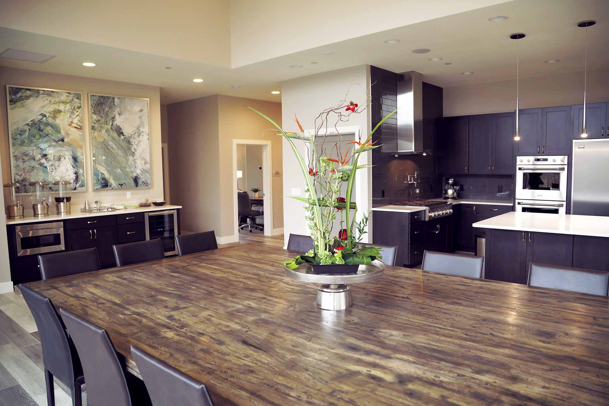 Communal dining room with large table and modern kitchen