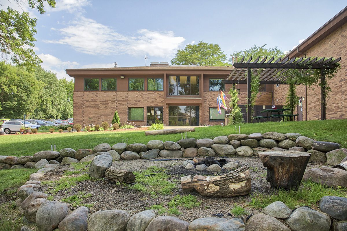 Outdoor fire pit area surrounded by rocks and trees