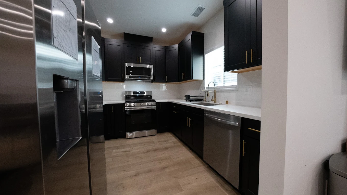 Modern kitchen with dark cabinets and stainless appliances