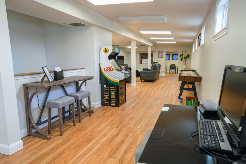 Game area with arcade machine and lounge seating